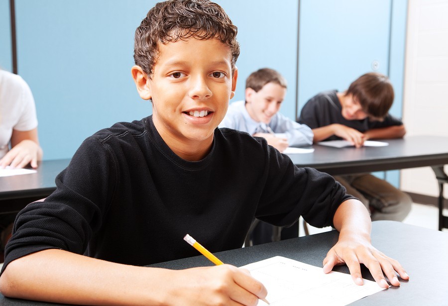 boy taking test in classroom