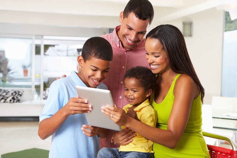 mom, dad, and kids with tablet