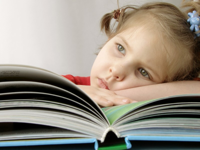young girl trying to read