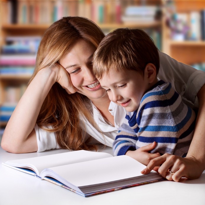 young boy and mother reading