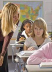 teacher helping girl in class