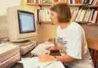 woman writing at computer