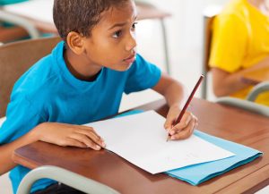 adorable african american primary school student studying Chinese in classroom