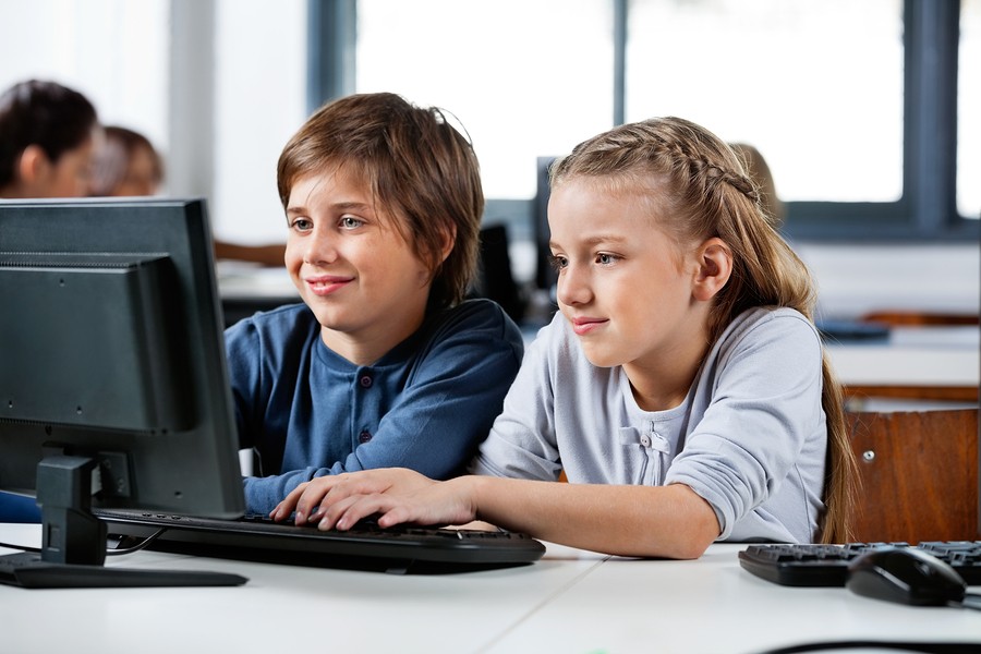 2 school kids at computer in class