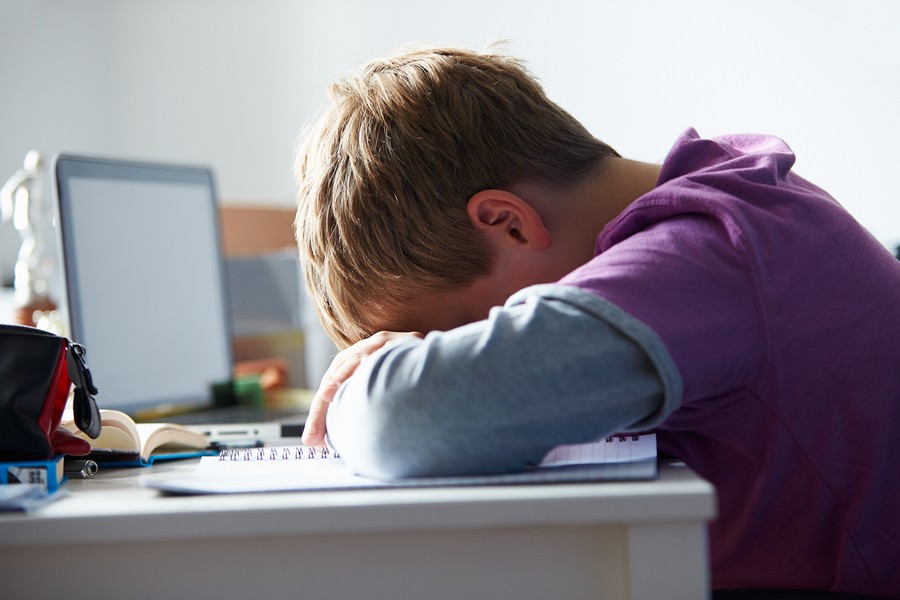 boy sleeping in class during tests