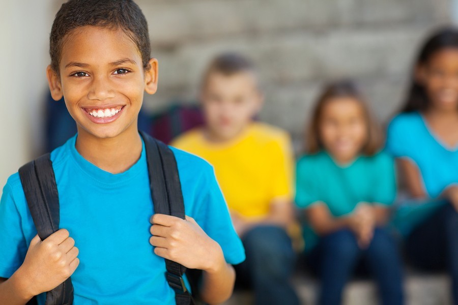 image of boy with backpack at school