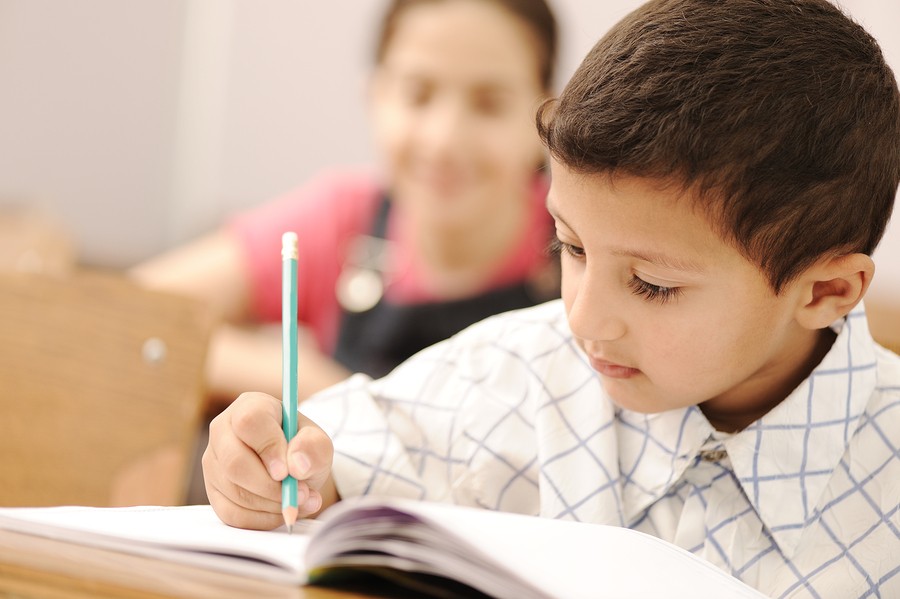 boy in class writing