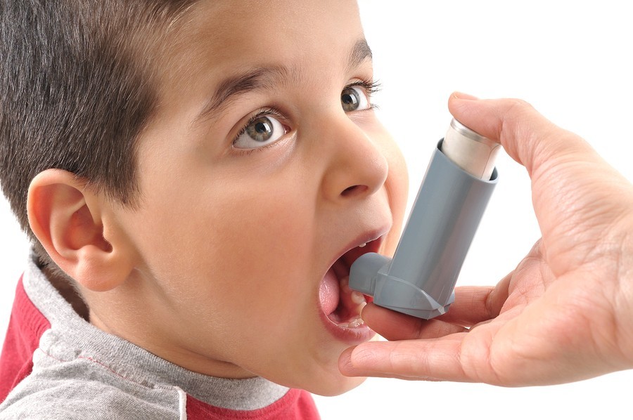 sick boy with inhaler