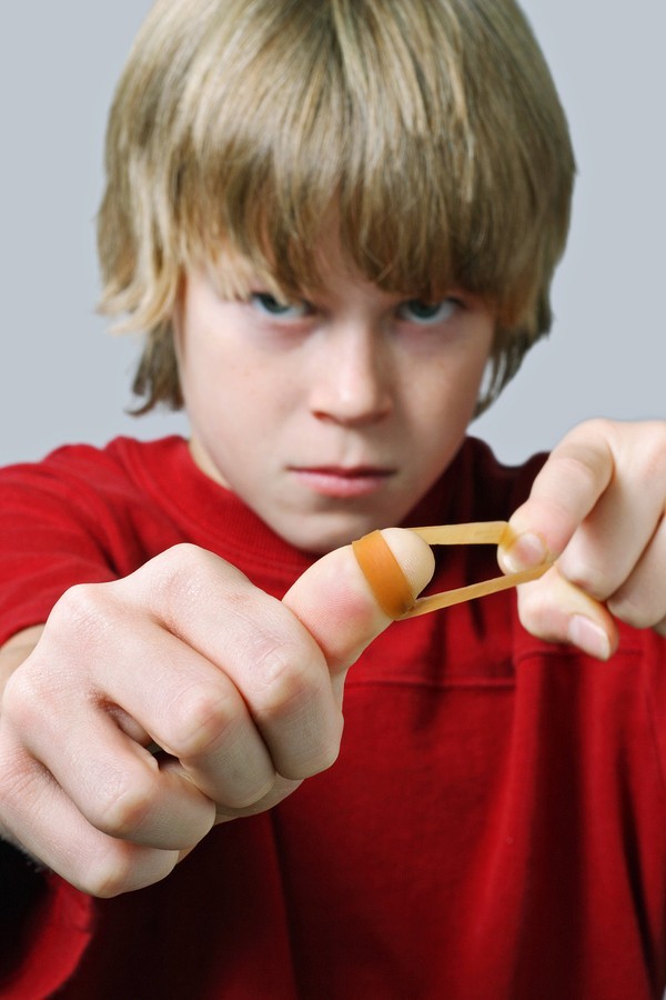 boy shooting rubber band