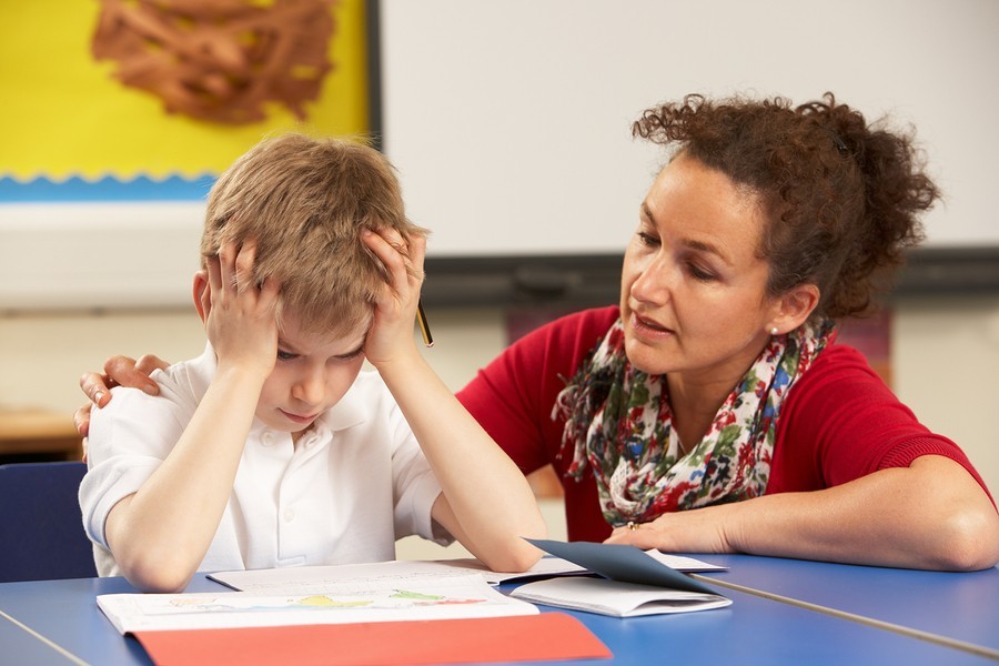 teacher with boy reading