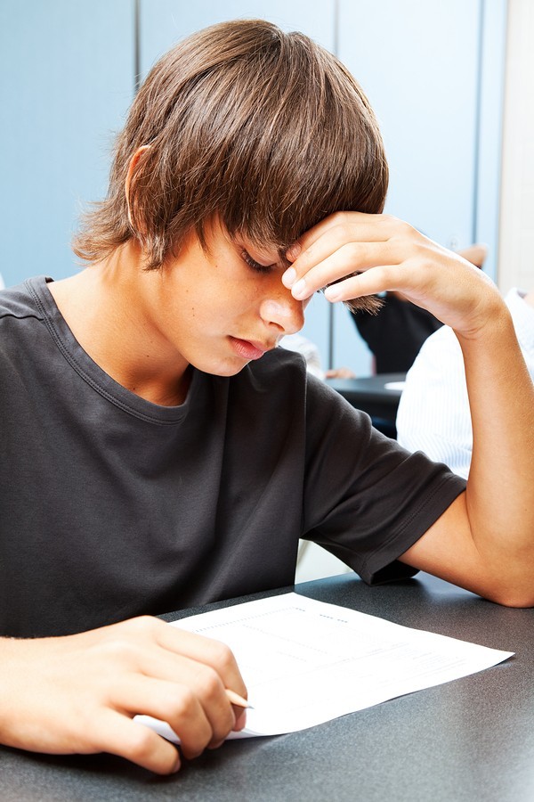 boy taking tests in class