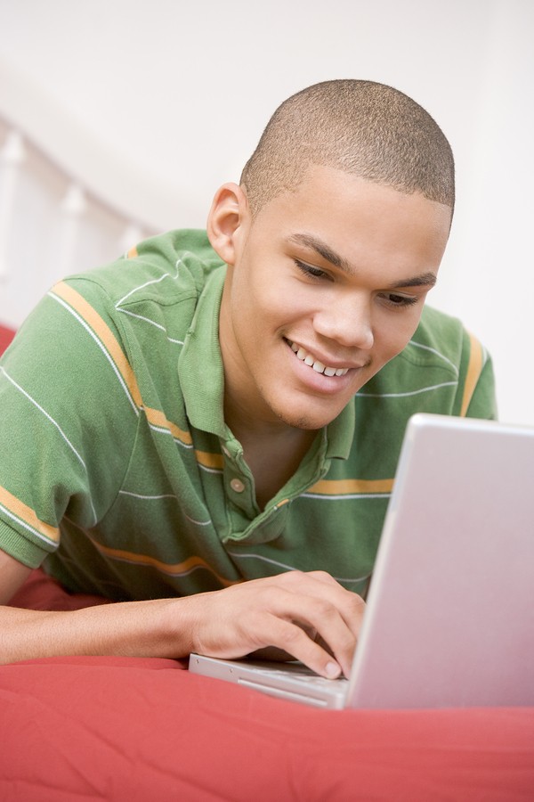 Happy student boy with computer