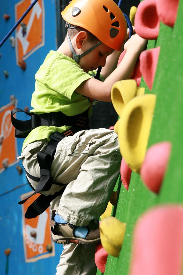 child climbing rock wall
