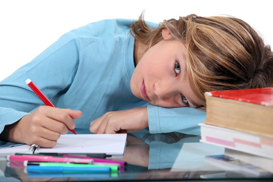 boy in class with head on desk