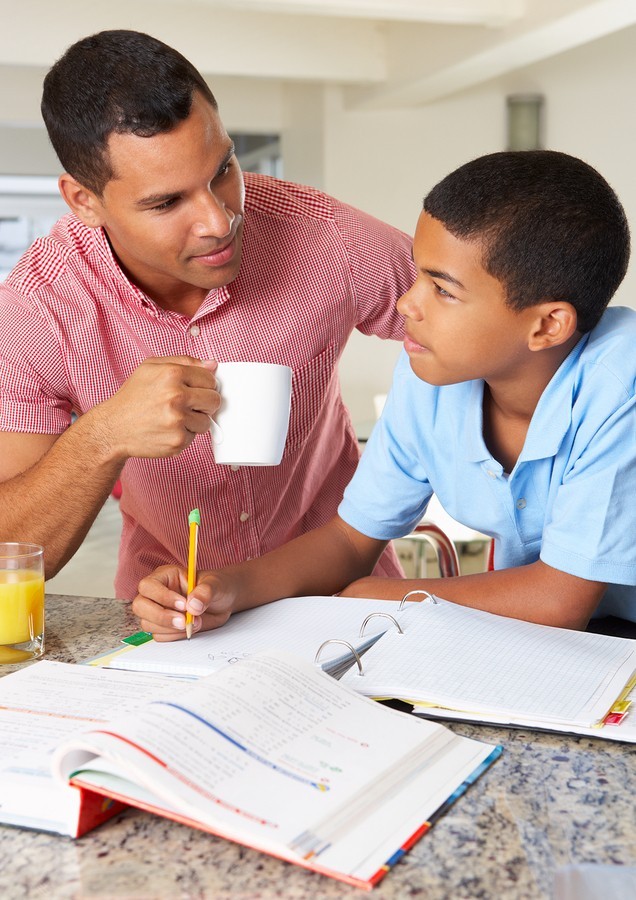 man and boy studying together