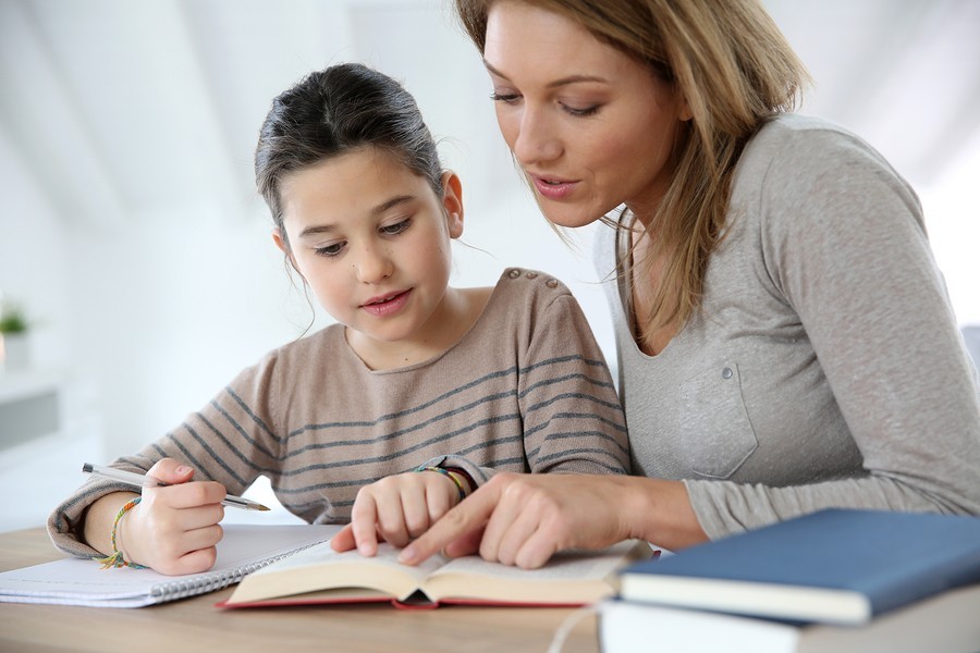 girl doing homework with mom