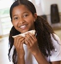 happy girl eating sandwich