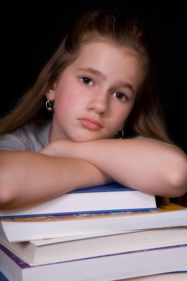 unhappy girl with books