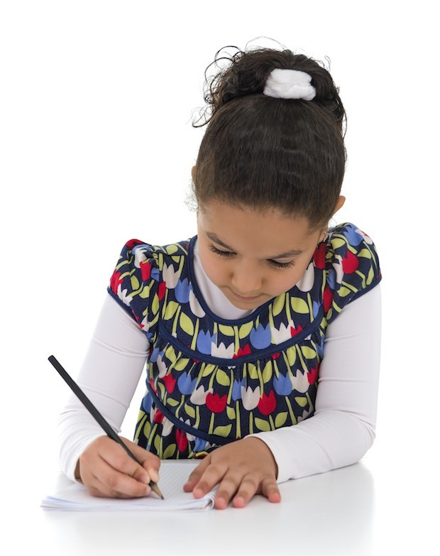 image of young girl writing in school