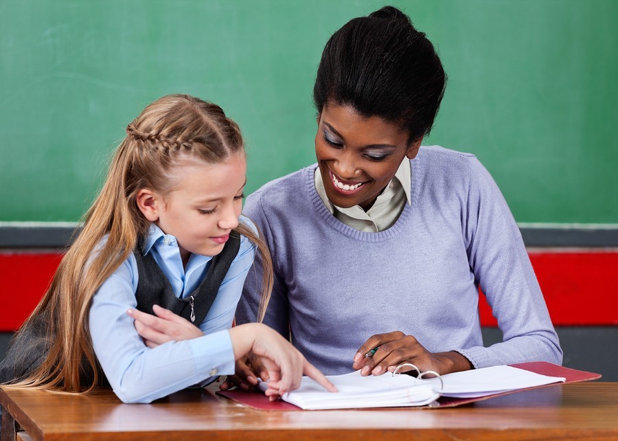 image of girl student reading with tutor or teacher