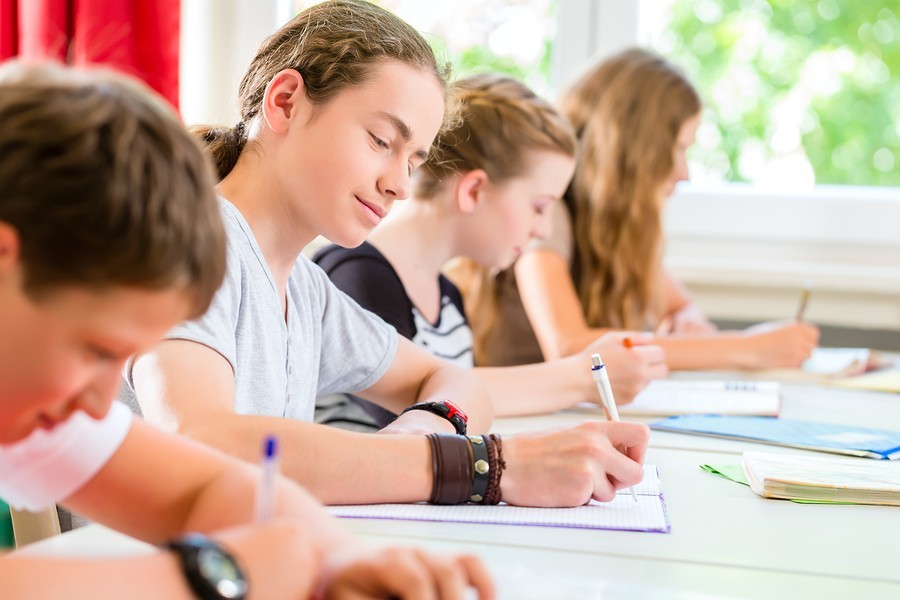 teacher giving boy a reading test