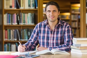 man in library reading