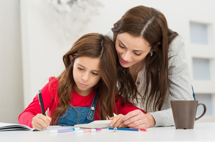 teacher with young girl in class