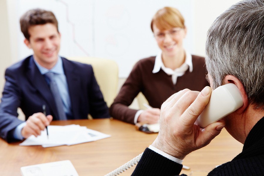 image of adults on phone at meeting