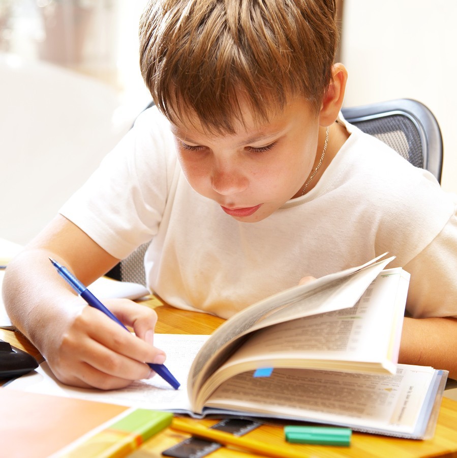 young boy reading at school