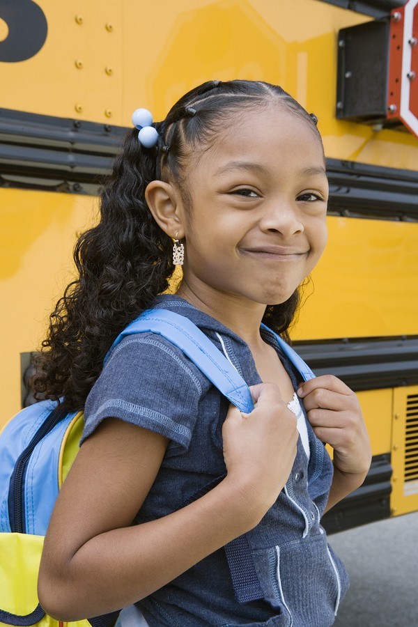 girl getting on school bus