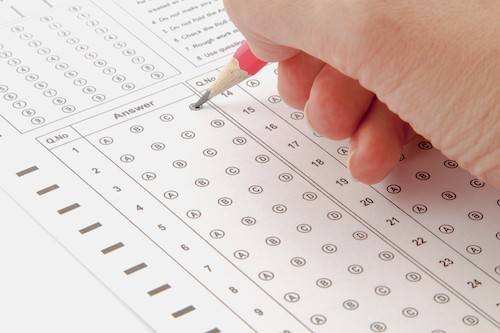 teacher giving student girl a reading test