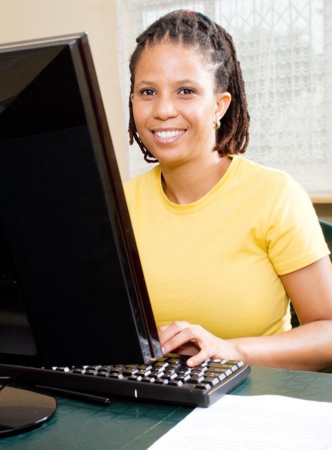 Woman writing at computer