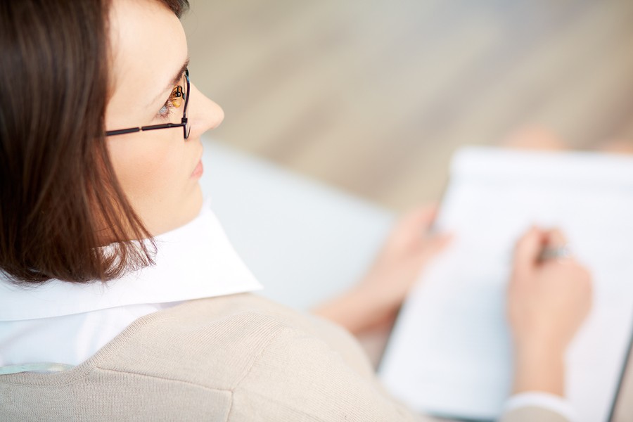 portrait of woman at a desk writing