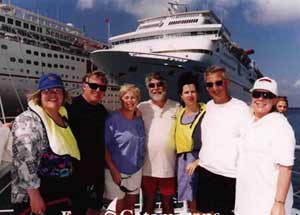 group of people standing in front of cruise ship