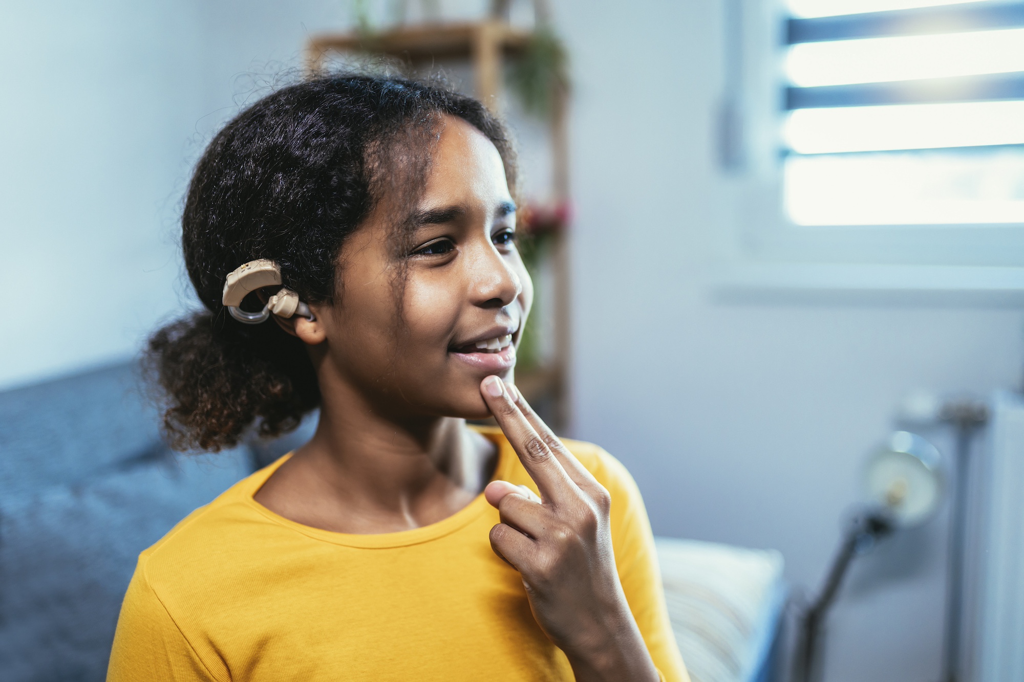 girl with a cochlear implant in class