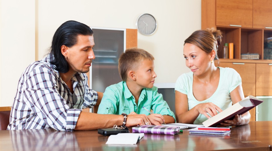 parents helping boy with homework