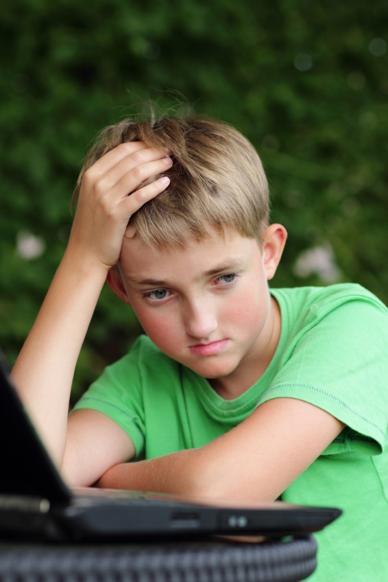 concerned school boy at computer