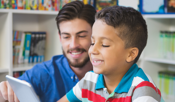 Young boy working with a reading specialist 