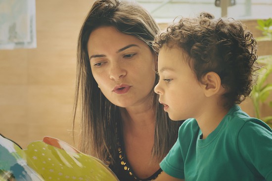 mom teaching young boy