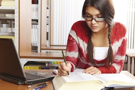 college student studying with her laptop