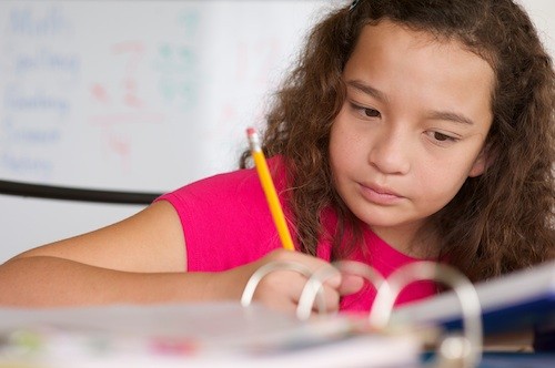 girl writing in school