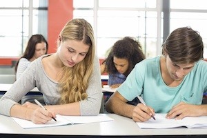 boy and girl in class taking tests