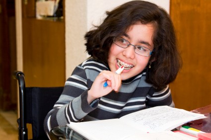 girl at school desk in wheelchair