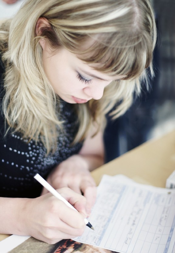 Girl writing assignment in school