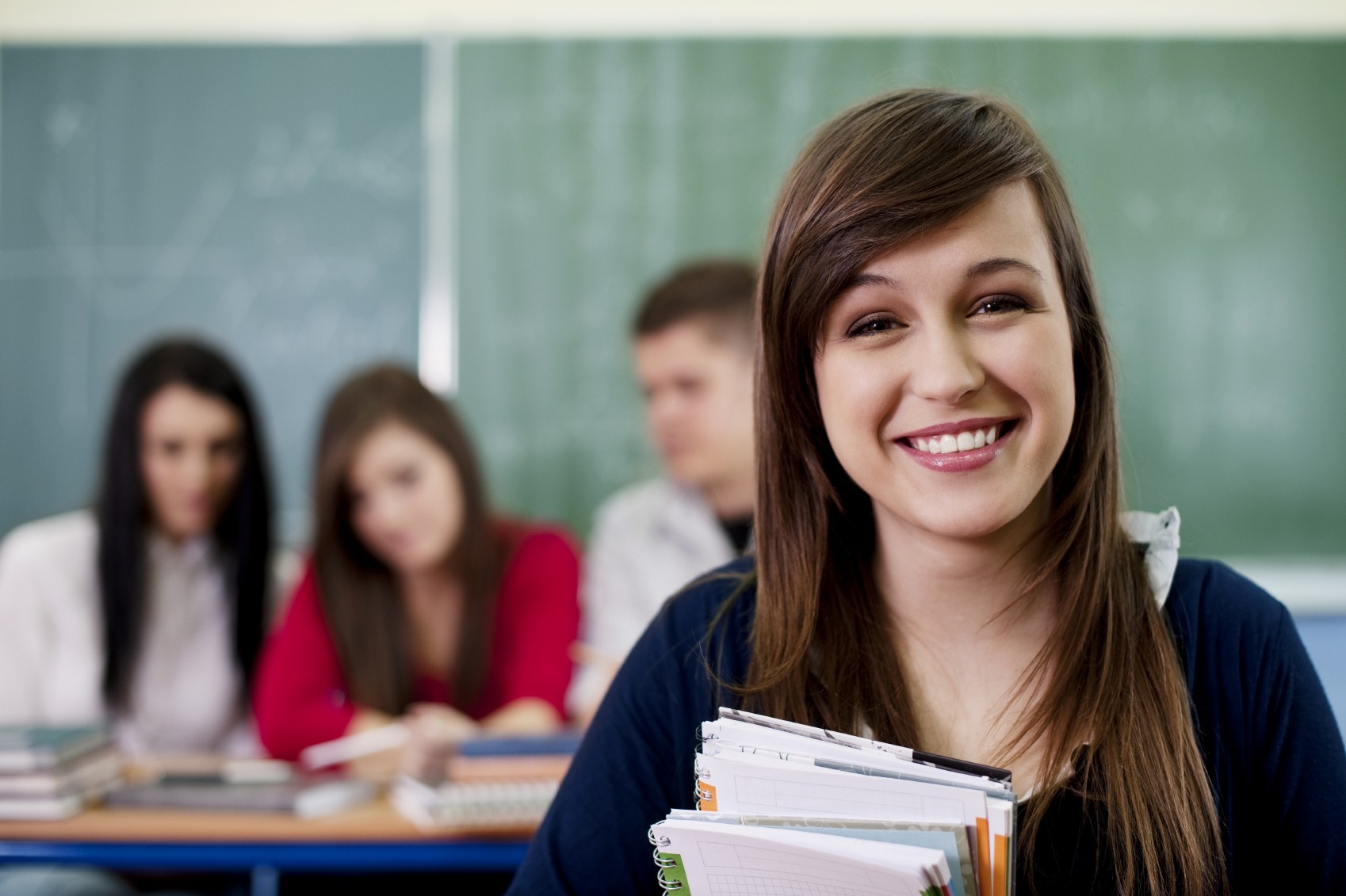 teen girl with books in class