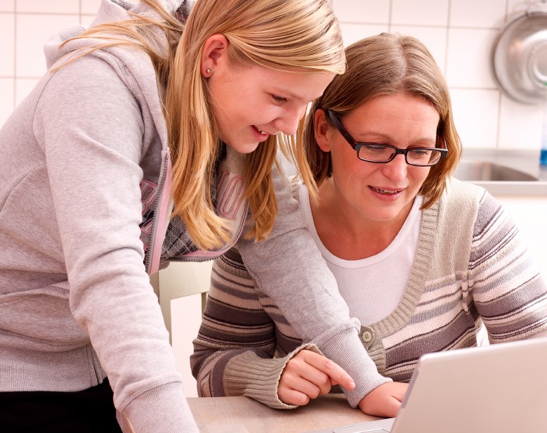 girl teen and mom at computer together