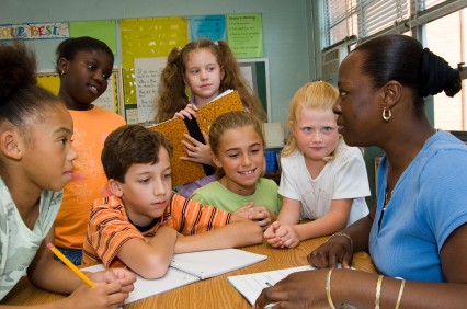 teacher with class around globe