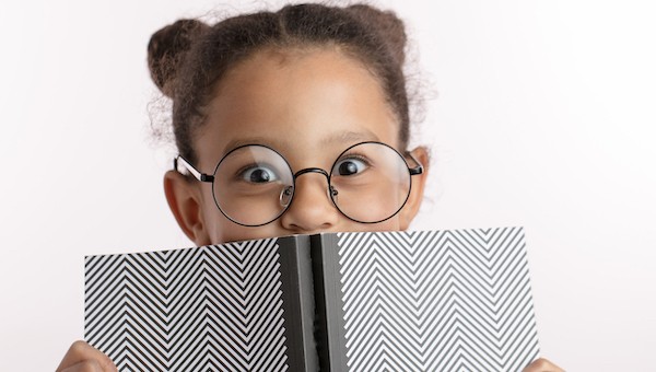 young girl excited about learning to read 