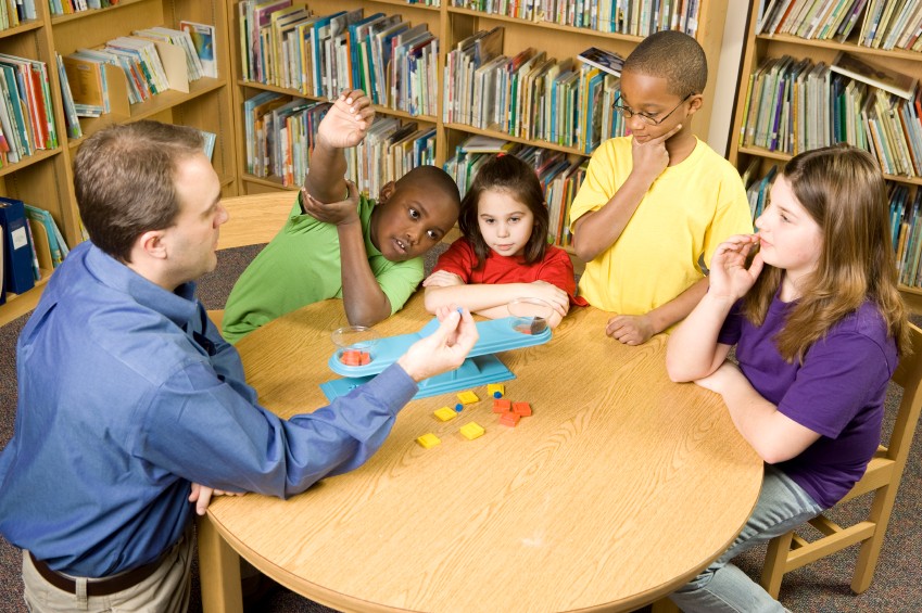 students and teacher in library