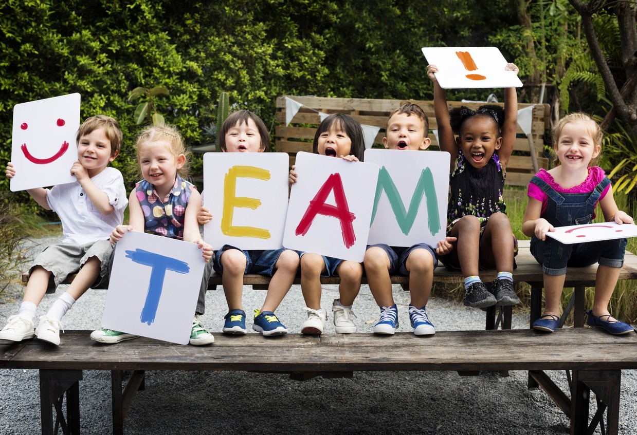 image of school kids with team sign